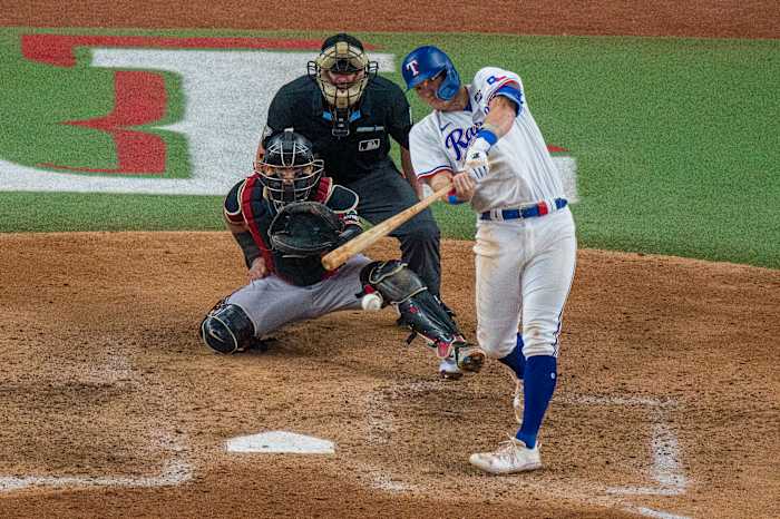 Oct 27, 2023; Arlington, Texas, USA; Texas Rangers third baseman Josh Jung (6) hits a single against the Arizona Diamondbacks during the sixth inning in game one of the 2023 World Series at Globe Life Field. Mandatory Credit: Jerome Miron-USA TODAY Sports